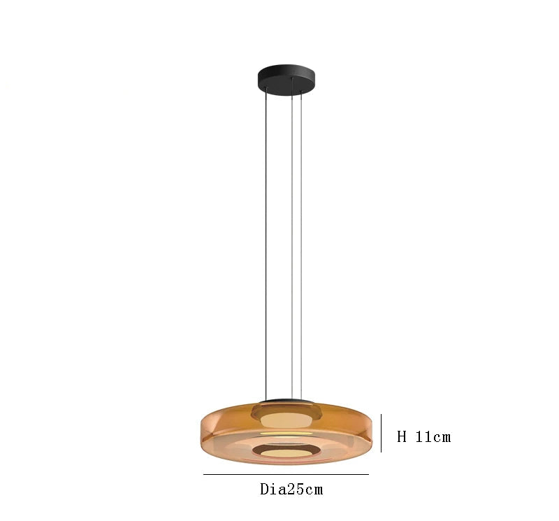 Amber glass pendant light with 25cm diameter and 11cm height. LED lighting and adjustable hanging for modern interiors.