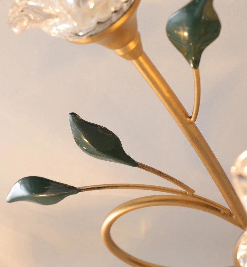 Detail of green leaf accents on gold arms of Vintage Glass Chandelier, enhancing the floral French romantic aesthetic.