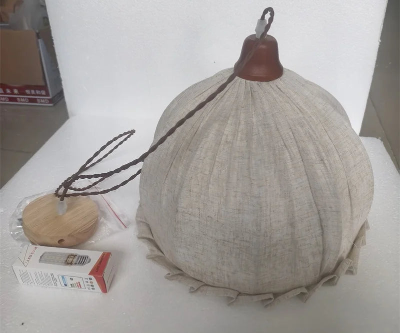 Unassembled Japanese fabric pendant lamp with LED bulb and mounting kit, ready for installation in home lighting setup.