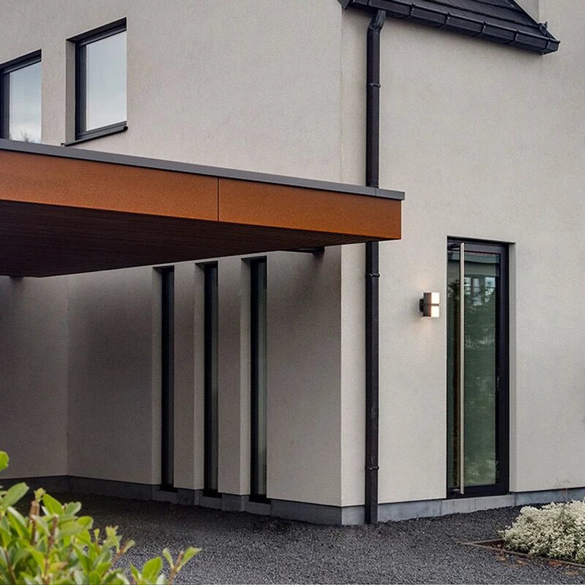 LUXELY rotatable outdoor wall lamp installed on modern villa exterior, enhancing curb appeal with waterproof and adjustable lighting.