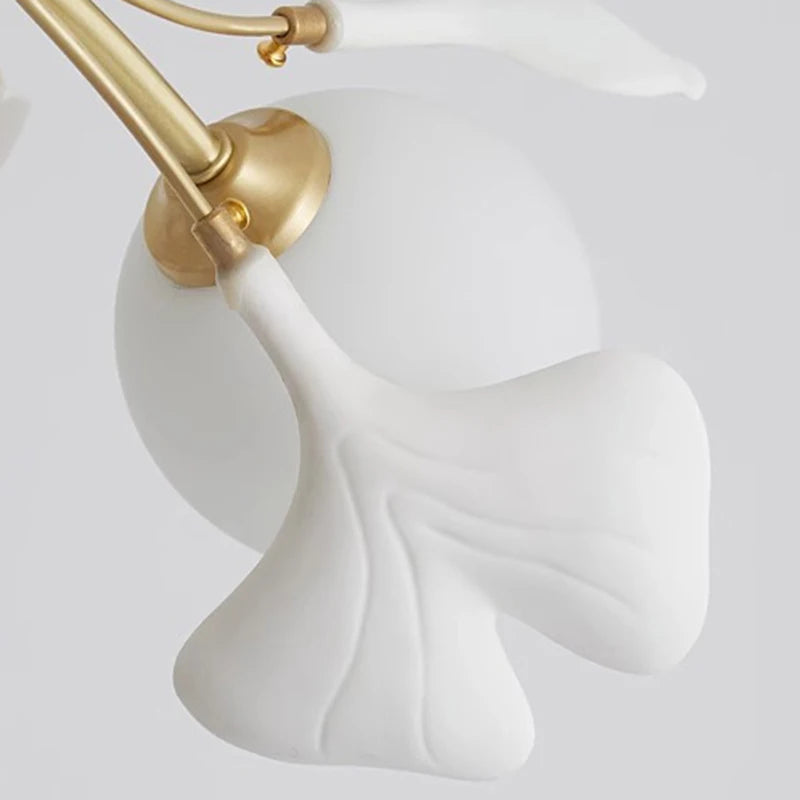 Close-up of white floral lamp shade and gold arm detailing on modern pendant light, highlighting premium craftsmanship.