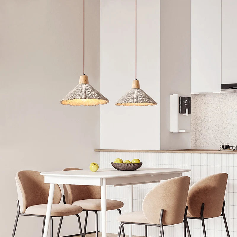 Pair of travertine minimalist pendant lamps above dining table, enhancing modern kitchen decor with natural textures and soft lighting.