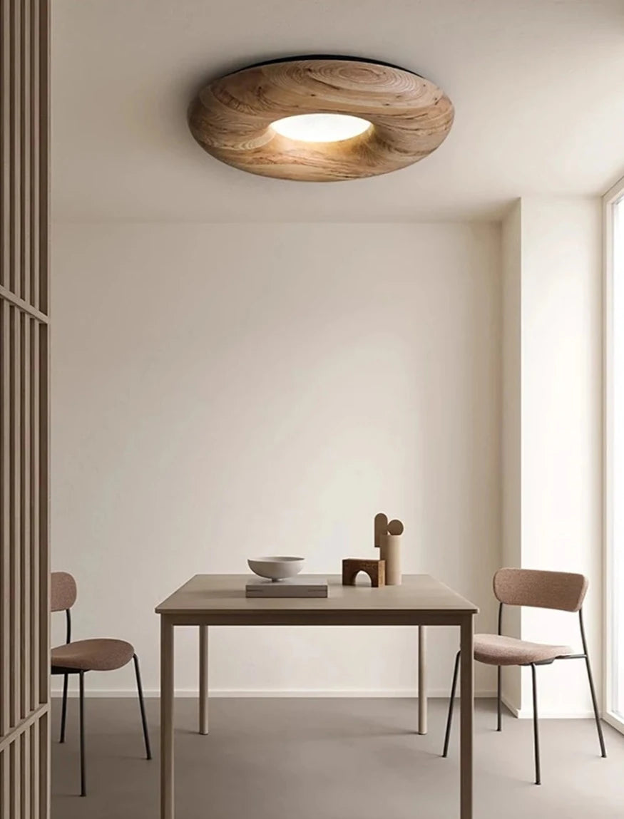 Minimalist dining room with light wood LUXELY ceiling lamp, offering soft LED lighting and Nordic-inspired design.