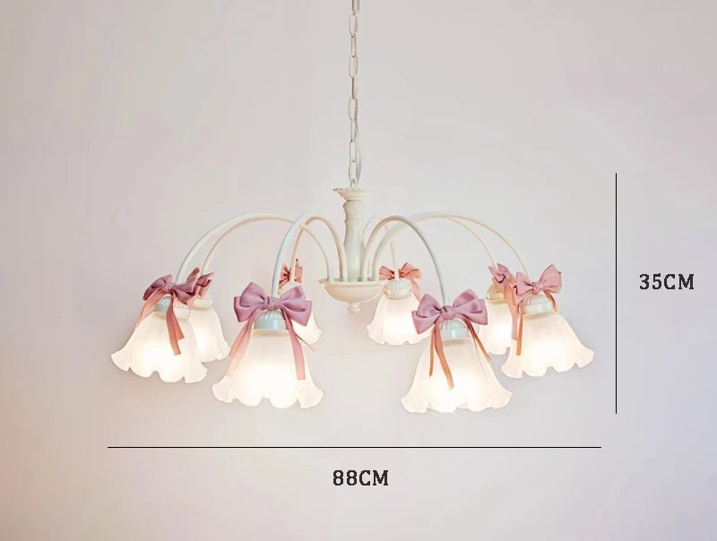Seven-light chandelier with scalloped glass and pink bows, 88cm wide and 35cm high, perfect for large elegant bedrooms.