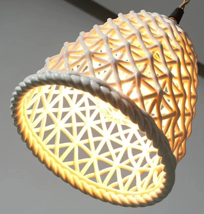 Illuminated LUXELY white ceramic pendant light with glowing lattice pattern, ideal for cozy dining or bedroom pendant lighting.