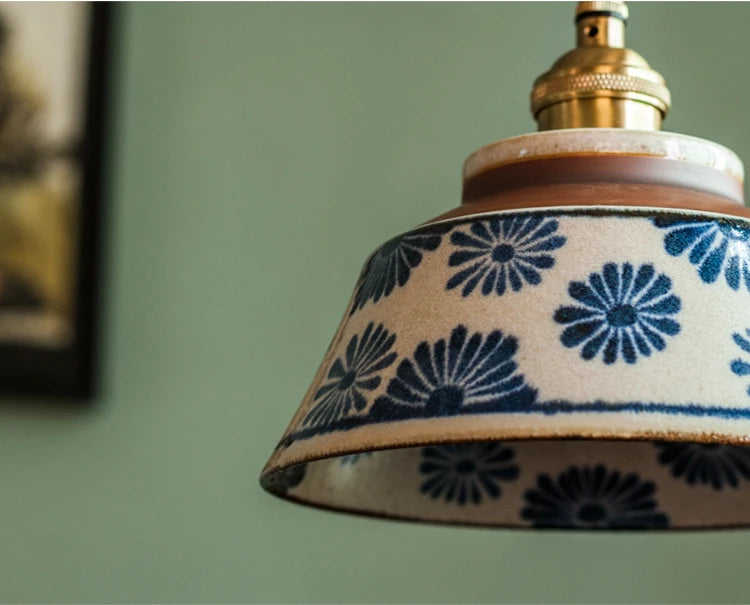 Side angle of blue floral Chinese Porcelain Pendant Light. Classic design with brass fixture and twisted cord.