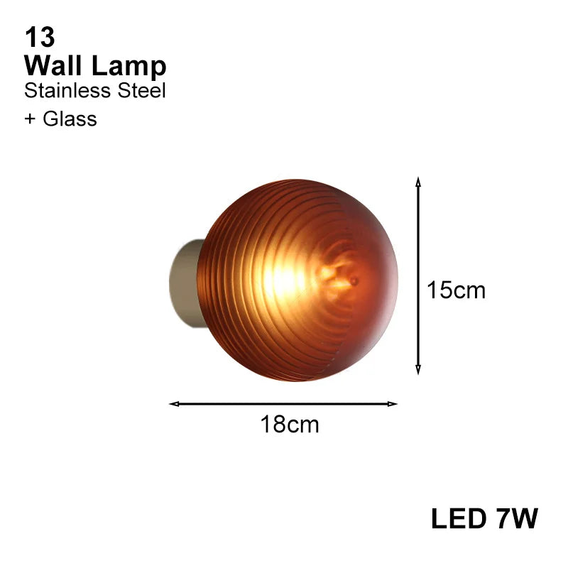 Amber-toned wall-mounted LED lamp with ribbed glass globe, 15cm diameter, ideal for warm accent lighting.
