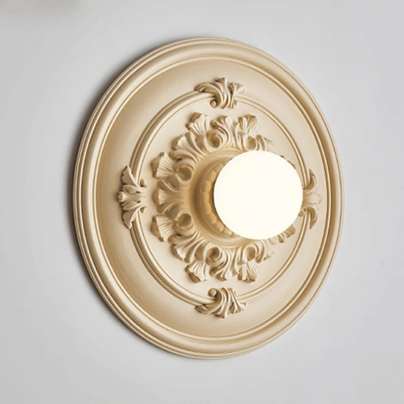 Beige LUXELY round wall sconce with vintage floral accents, perfect for classic bedroom or living room decor.