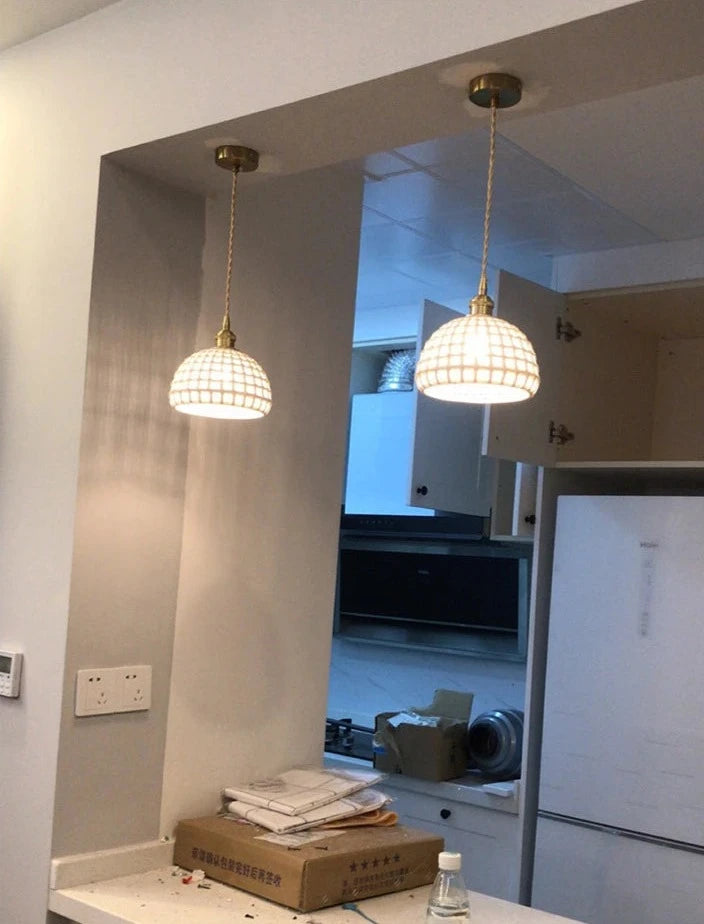 Two white LUXELY ceramic Japanese pendant lights installed above a kitchen counter, enhancing modern home lighting aesthetics.