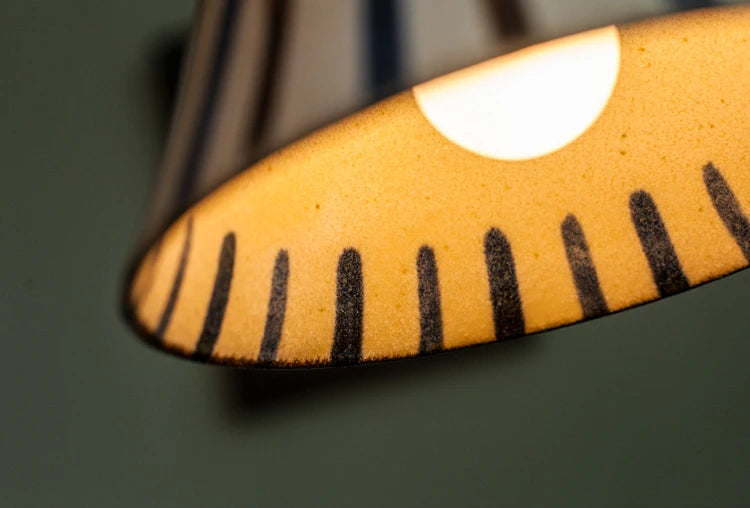 Interior view of striped Retro Chinese Porcelain Pendant Light. Soft LED light enhances hand-painted ceramic.