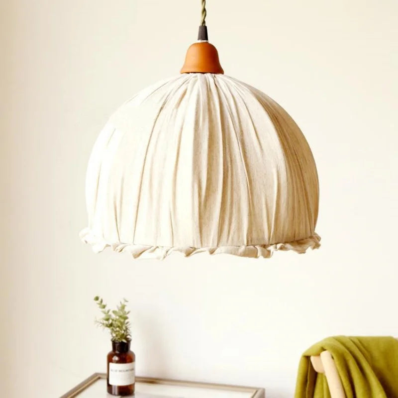 Modern minimalist fabric pendant light with soft ruffled edge, perfect for cozy living room or dining area ambiance.