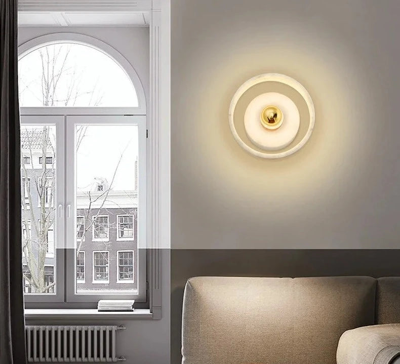 Wabi-sabi marble wall lamp mounted in a living room, blending with Nordic interior for soft, ambient lighting.