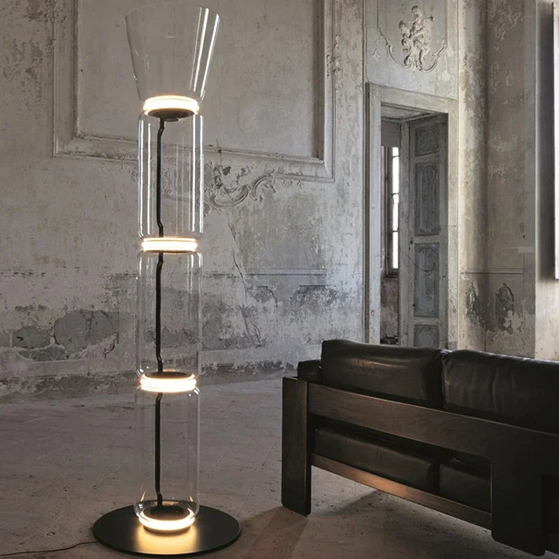 Tall Italian glass floor lamp – modern minimalist nordic design with stacked LED-lit glass sections in a vintage interior setting.