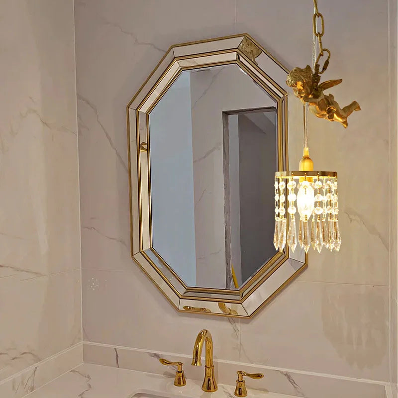 Copper angel chandelier pendant light installed above a bathroom vanity, adding elegance with crystal lighting.