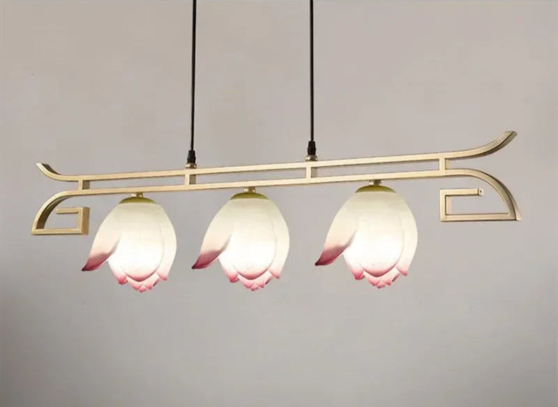 Three-light horizontal lotus flower LED pendant light with curved gold frame, ideal for kitchen islands or dining areas.