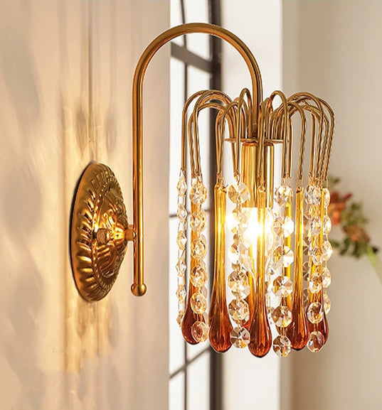 Close-up of French Retro Teardrop Crystal Wall Lamp with copper frame and crystal drops, radiating warm light for luxury interiors.