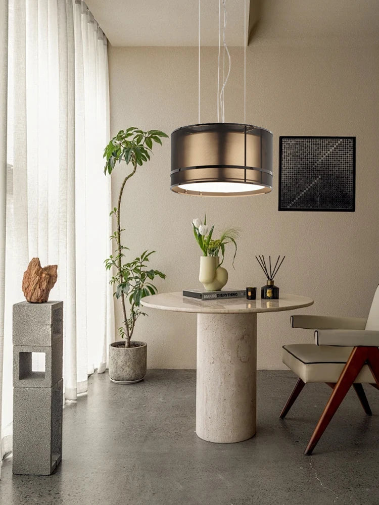 Italian designer ceiling chandelier illuminating a cozy dining nook with a round stone table and indoor plants, ideal for modern interiors.