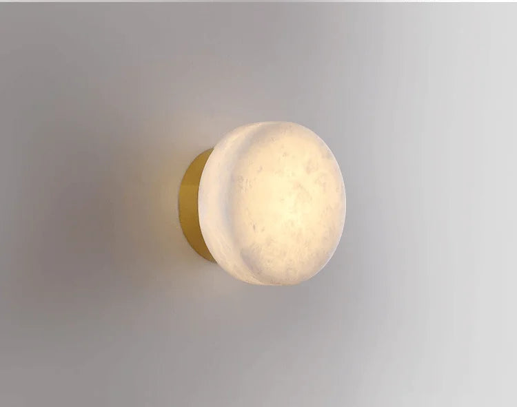 Modern LED Marble Wall Lamp with gold base and marble shade, offering a luxurious lighting option for living spaces.