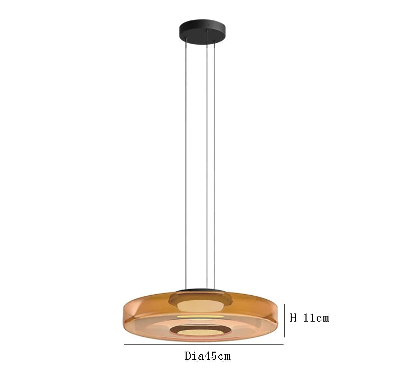 Amber glass pendant light with 45cm diameter and 11cm height. LED lighting and adjustable hanging for luxury interiors.