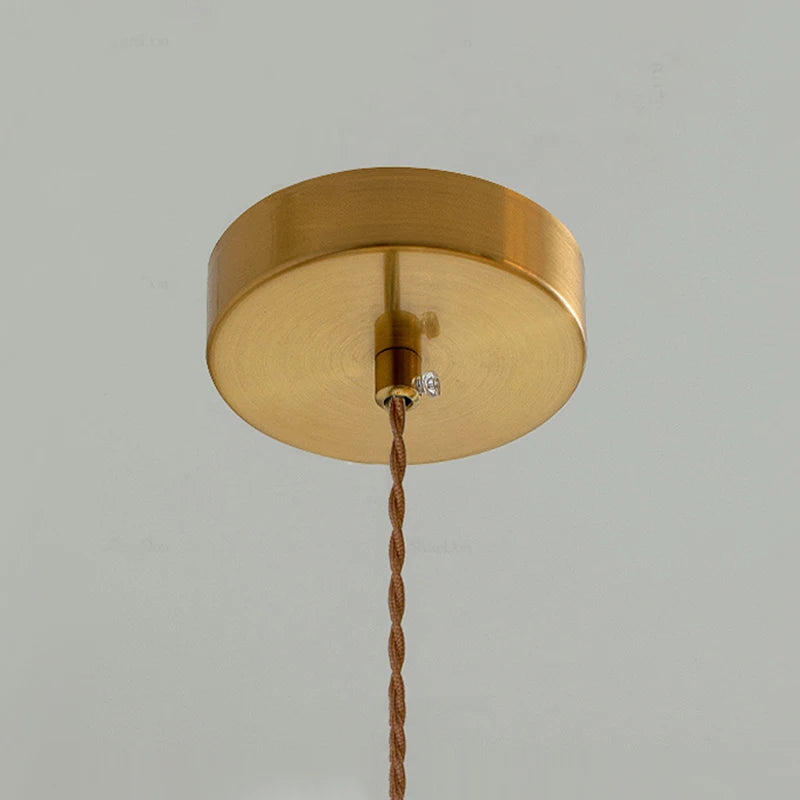 Brass ceiling mount with twisted cord for the French Modern Cream Chandelier, designed for secure and stylish pendant installation.