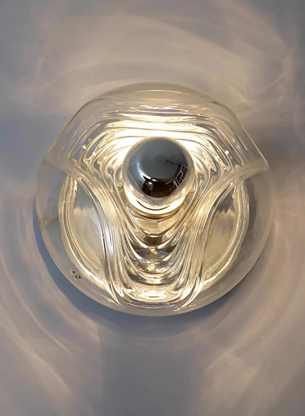 Overhead view of modern LED wall lamp with clear glass design, perfect for stylish home or restaurant lighting.