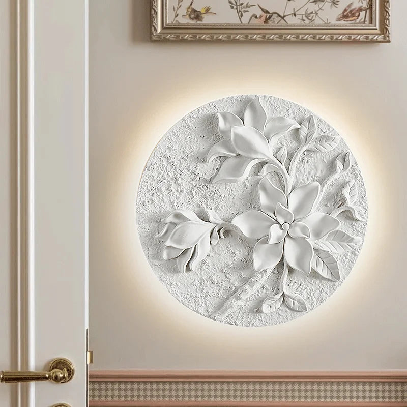 Textured round vintage wall sconce with sculpted floral motif, perfect for adding French elegance to kitchens or hotel hallways.