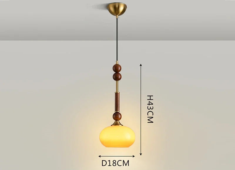 Modern Art Hanging Lamp with amber glass globe and wood stem, a Nordic pendant light for warm ambient lighting.