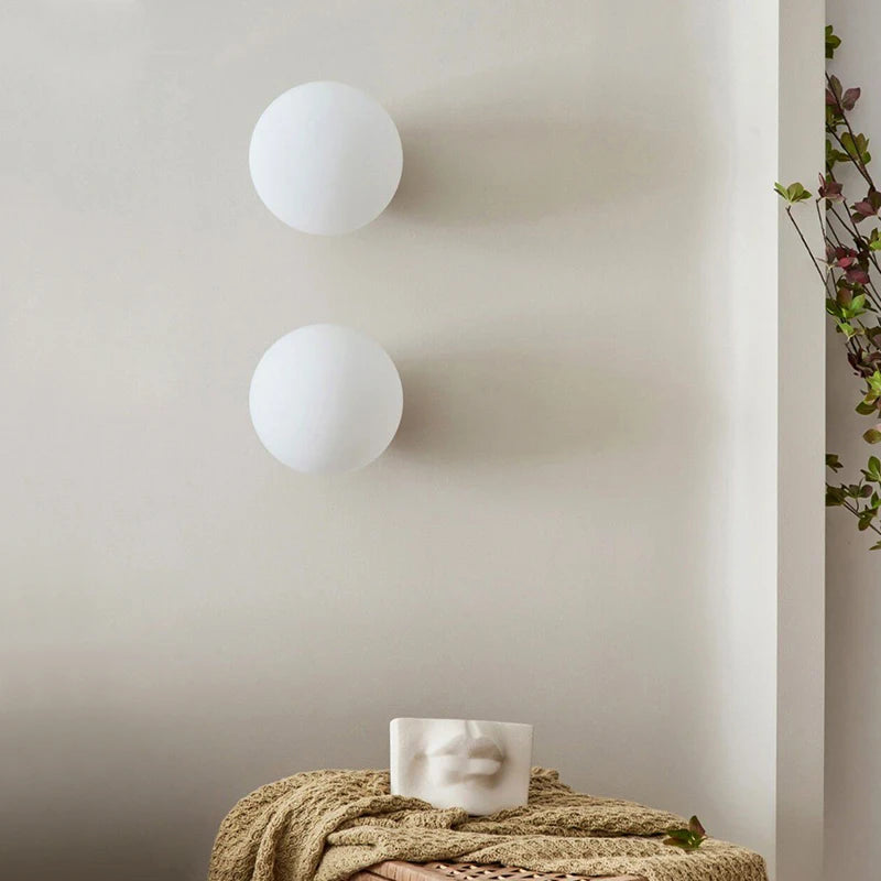 LUXELY brass accent wall lights in a minimalist living space, ideal for modern interiors with soft white illumination and sculptural appeal.