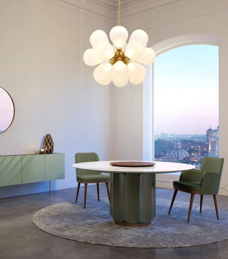 Scandinavian pendant light with white glass bubbles and gold finish, featured in a modern dining room with panoramic views.