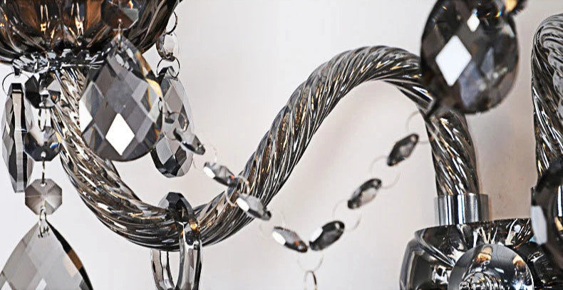 Close-up of twisted crystal arm and hanging droplets on vintage lotus wall sconce, showcasing intricate craftsmanship.