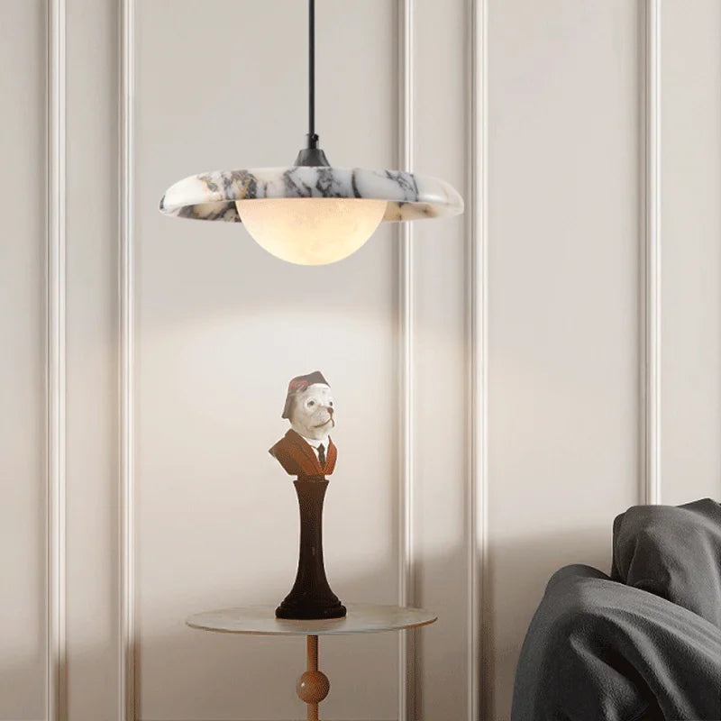Matte Marble Pendant Lamp with black round marble shade above a side table, perfect for bedroom or study lighting.
