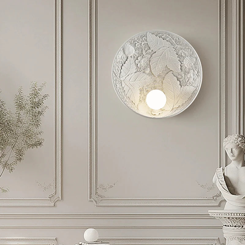 Vintage French round wall lamp in ornate room setting, showcasing elegant leaf and flower patterns for luxury home lighting.