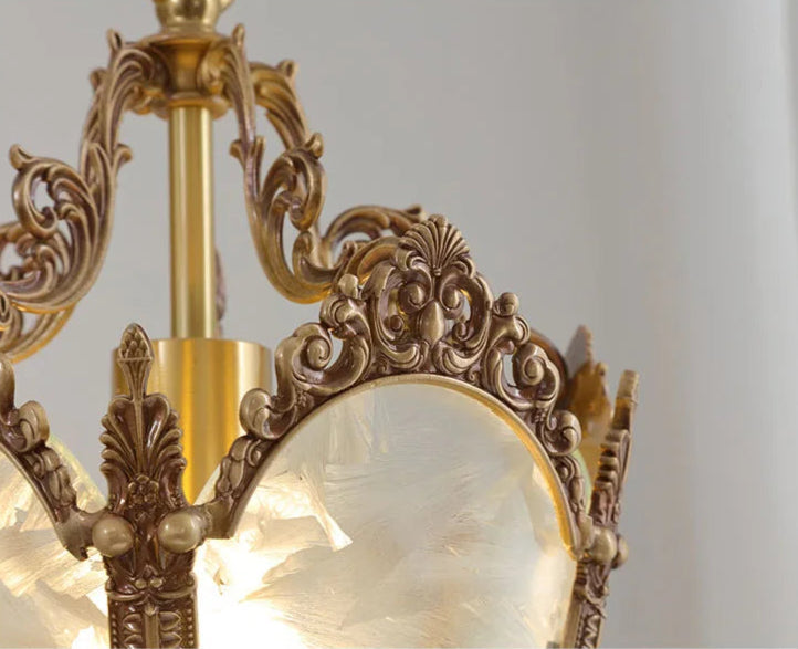 Close-up of ornate copper scrollwork and frosted glass on French retro chandelier. Durable and decorative lighting piece.
