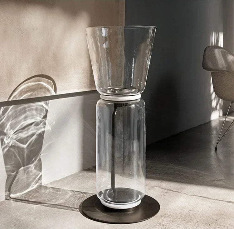 Contemporary Italian glass floor lamp – minimalist nordic design with LED lighting and wide top glass shade in a bright room.