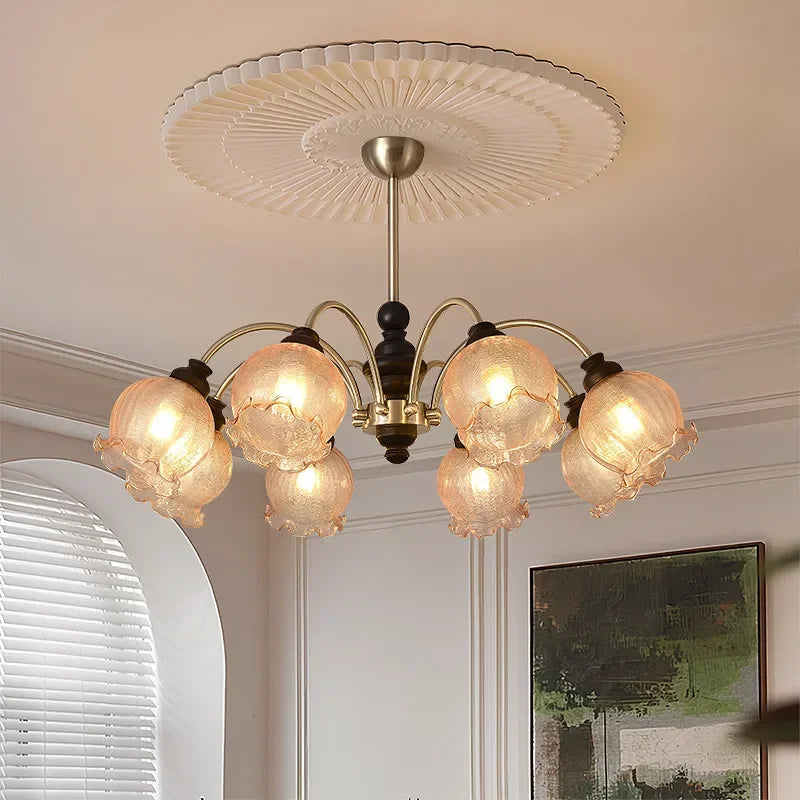 Black and gold American chandelier with six LED crystal shades, mounted on a white ceiling medallion in a stylish home setting.