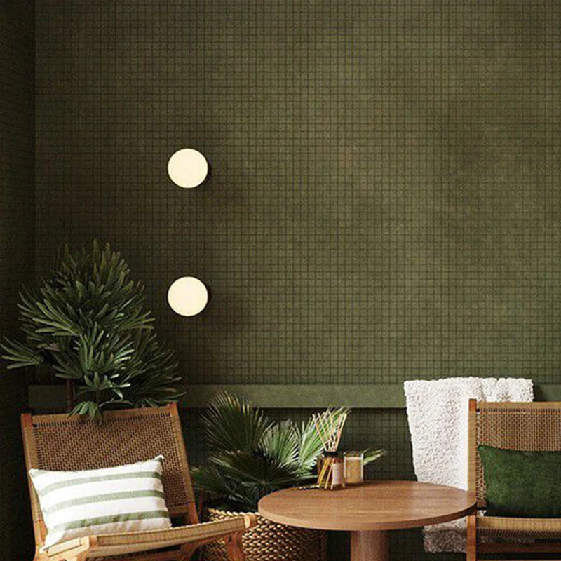 LUXELY modern wall lights with brass accents mounted on a green textured wall, enhancing cozy seating area with soft ambient lighting.
