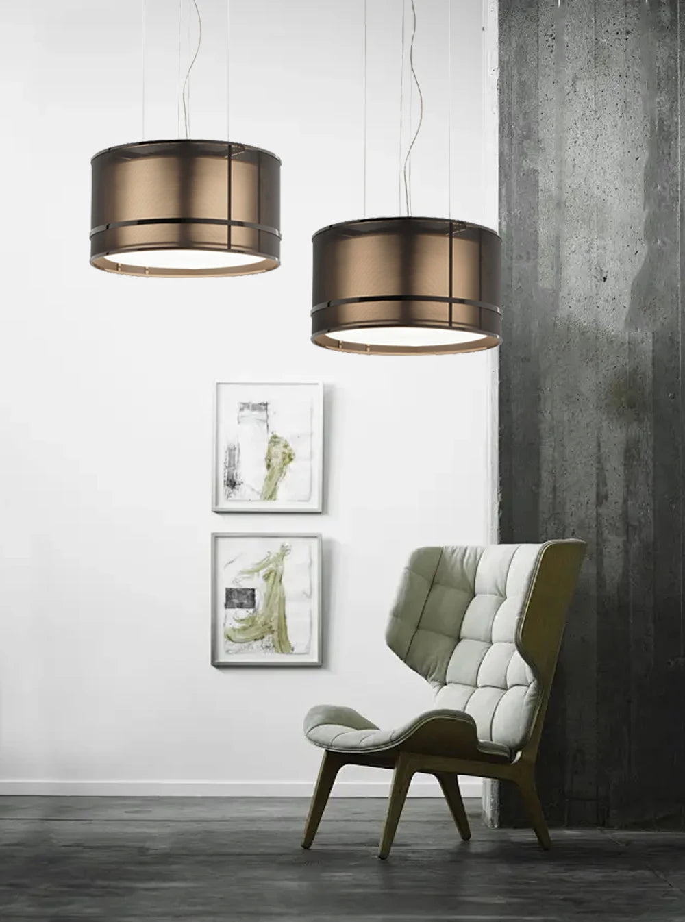Pair of Italian designer ceiling chandeliers hanging in a modern lounge with a high-back chair and minimalist decor.