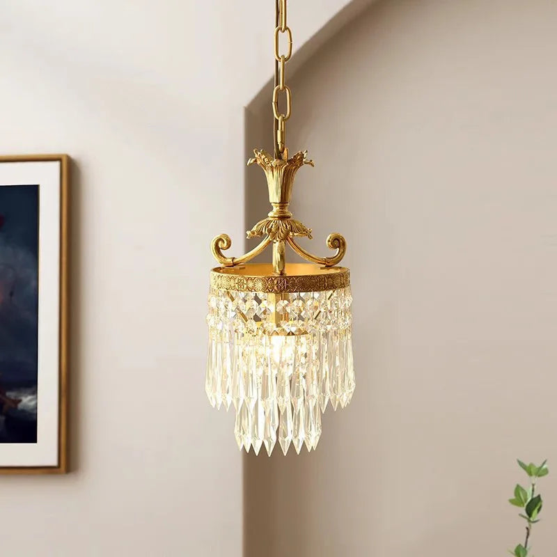 Elegant small copper crystal chandelier with warm lighting, perfect for vintage-inspired home decor in bedrooms or porches.