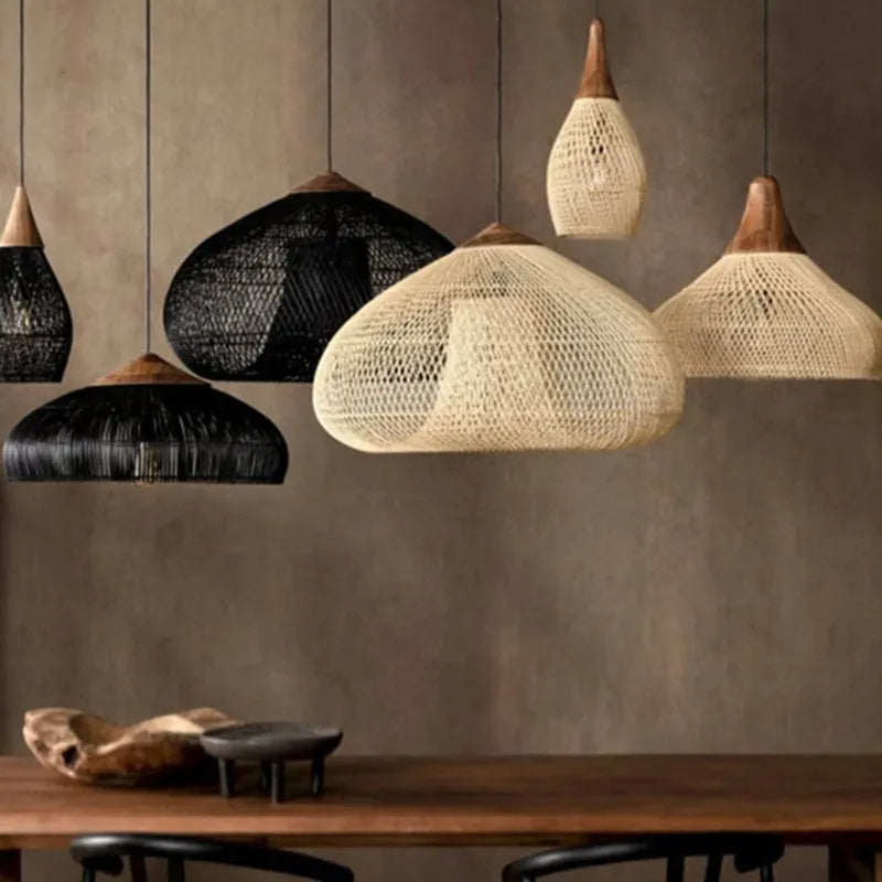 Mixed black and natural rattan pendant lights with wood accents, perfect for kitchen islands or restaurant lighting setups.