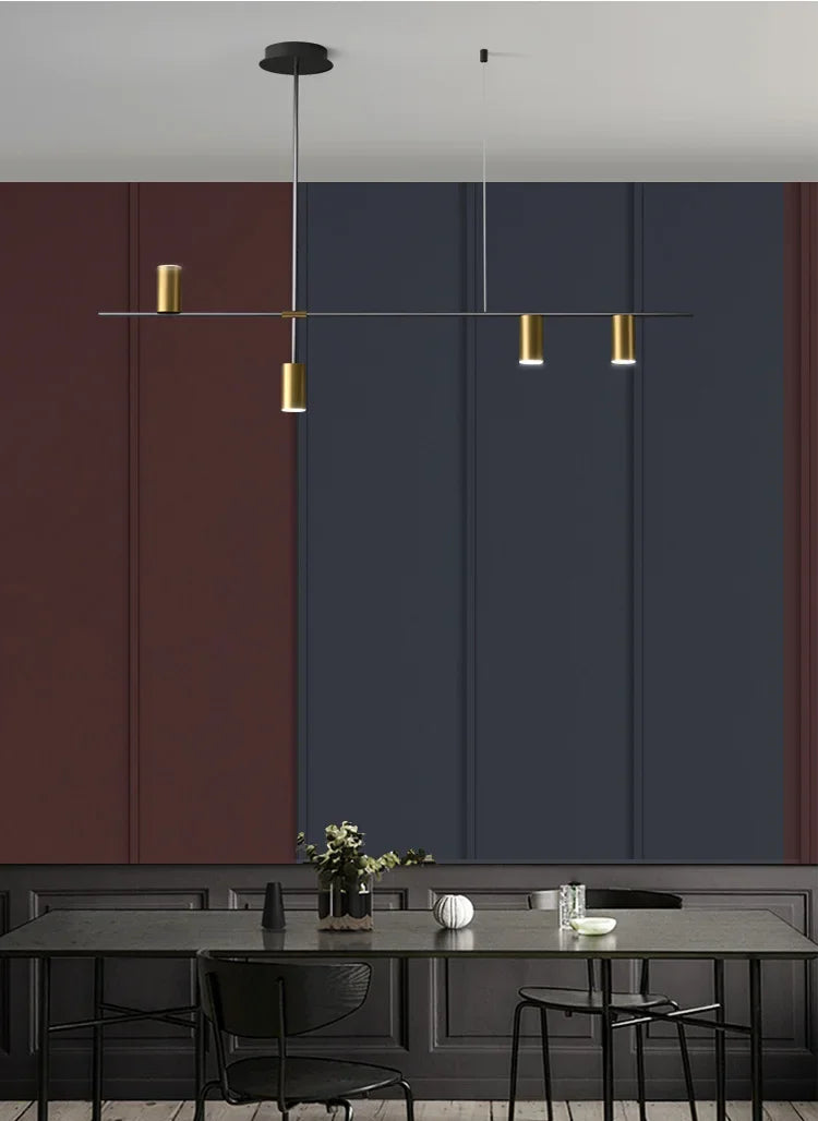 Gold spotlight version of modern minimalist ceiling light installed in a stylish dining room with dark accent walls and black furniture.