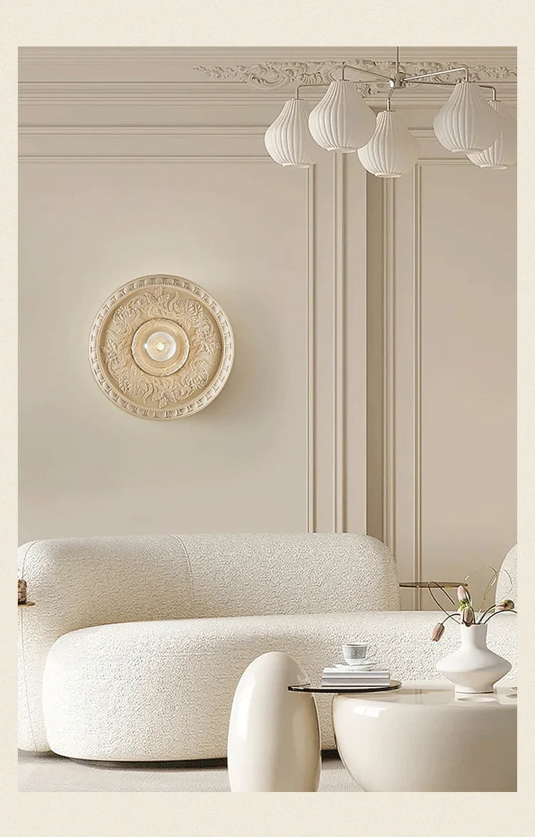 Beige art deco wall lamp by LUXELY illuminating a chic living room, perfect for upscale home or hotel interiors.