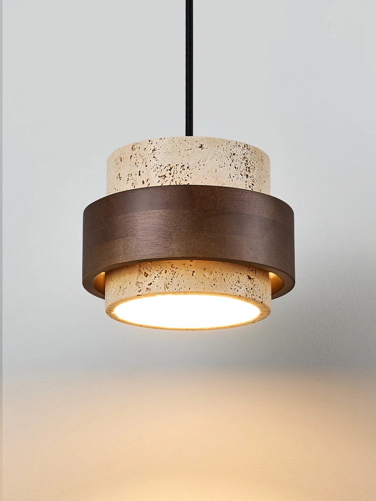 Travertine pendant lamp bedside in wabi-sabi style, combining rustic stone and wood for ambient ceiling lighting in home interiors.