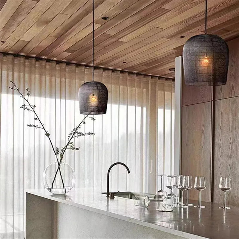 Black LUXELY wabi sabi rattan pendant lights above a modern kitchen island, blending industrial style with natural textures.