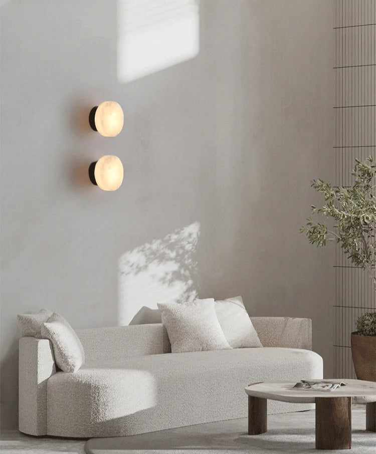 Two Modern LED Marble Wall Lamps installed above a sofa in a minimalist living room, providing elegant and functional lighting.