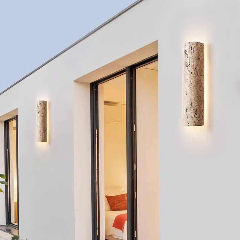 IP65 travertine stone wall lights installed beside sliding doors, enhancing outdoor living space with soft illumination.