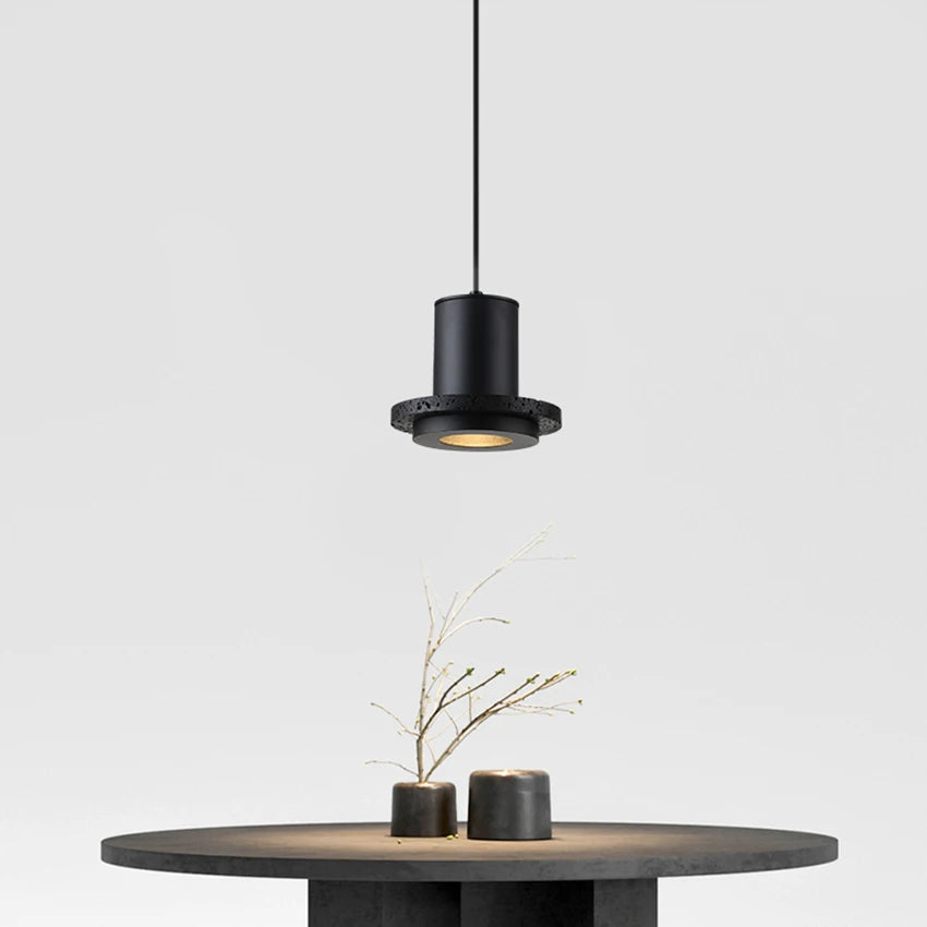 Minimalist dining setup with a LUXELY black stone pendant lamp centered above a round table, ideal for modern interiors.