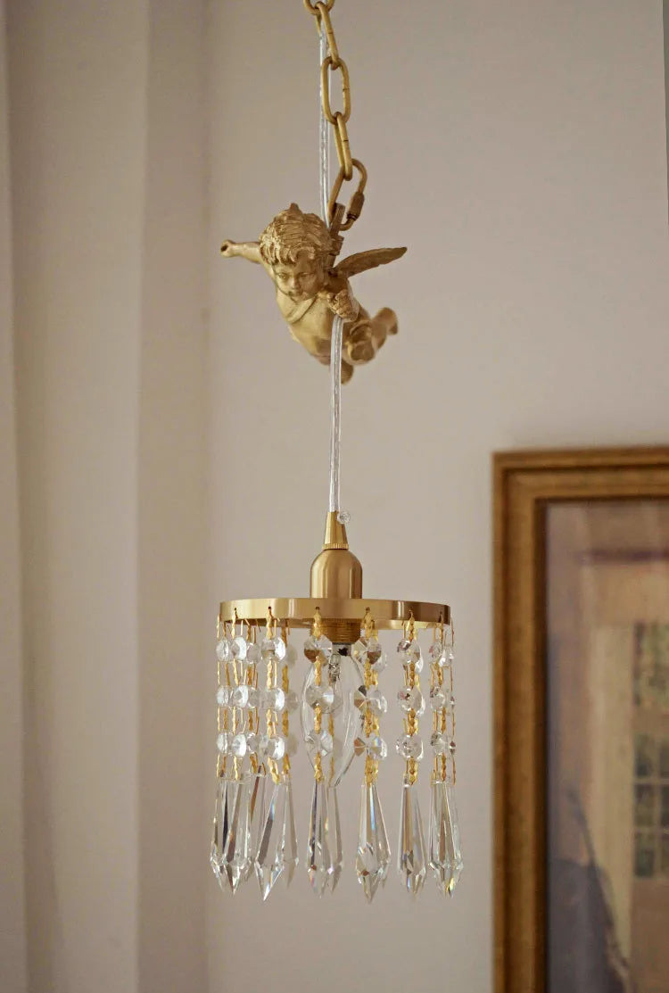Back view of copper angel chandelier light with hanging crystal pendant, showcasing detailed angel wings and gold finish.