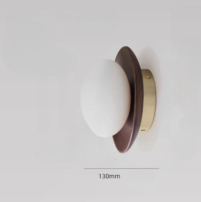 Side profile of walnut wood and brass wall lamp with 130mm diameter, perfect for compact modern spaces.