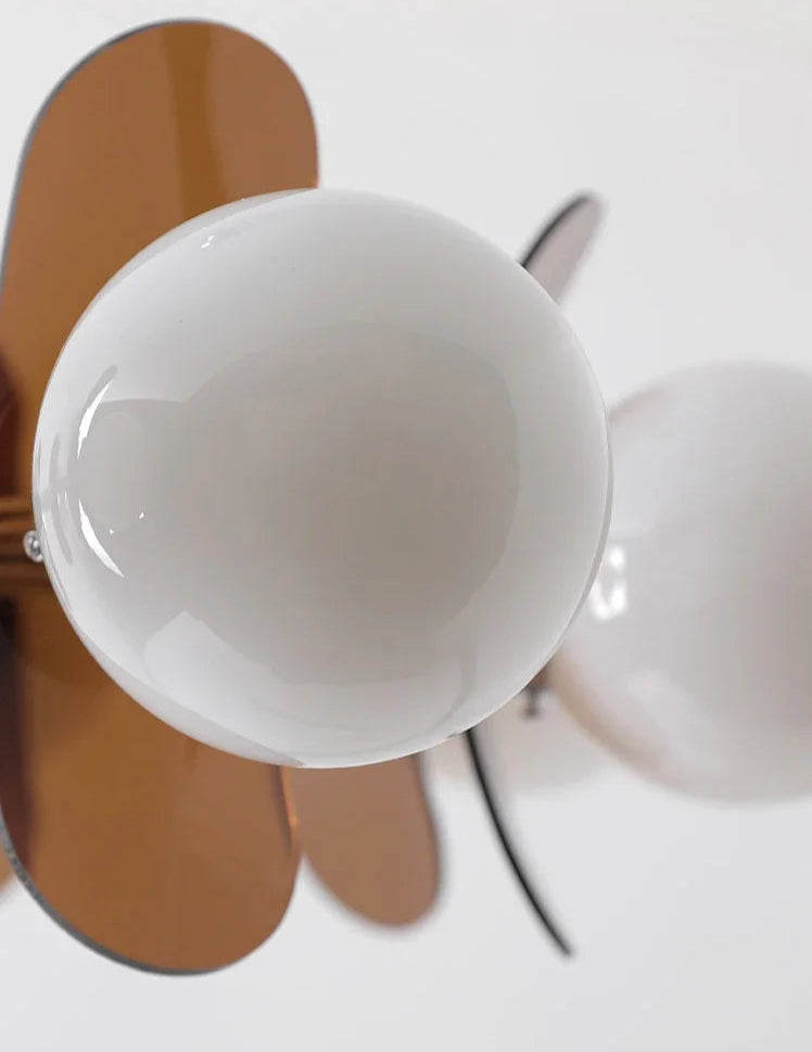 Macro shot of LED globe and brown acrylic panel on Bauhaus retro chandelier, emphasizing its modern artistic lighting style.