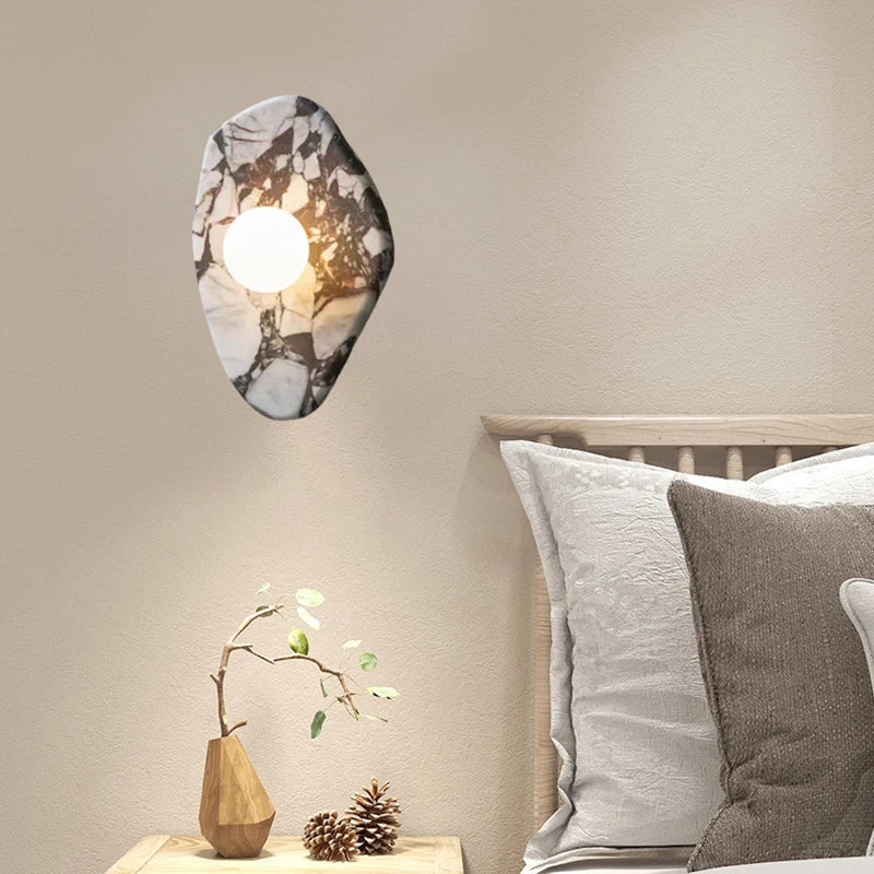 Natural Stone Wall Light with G9 glass ball sconce mounted beside a bed, perfect for cozy bedroom lighting.